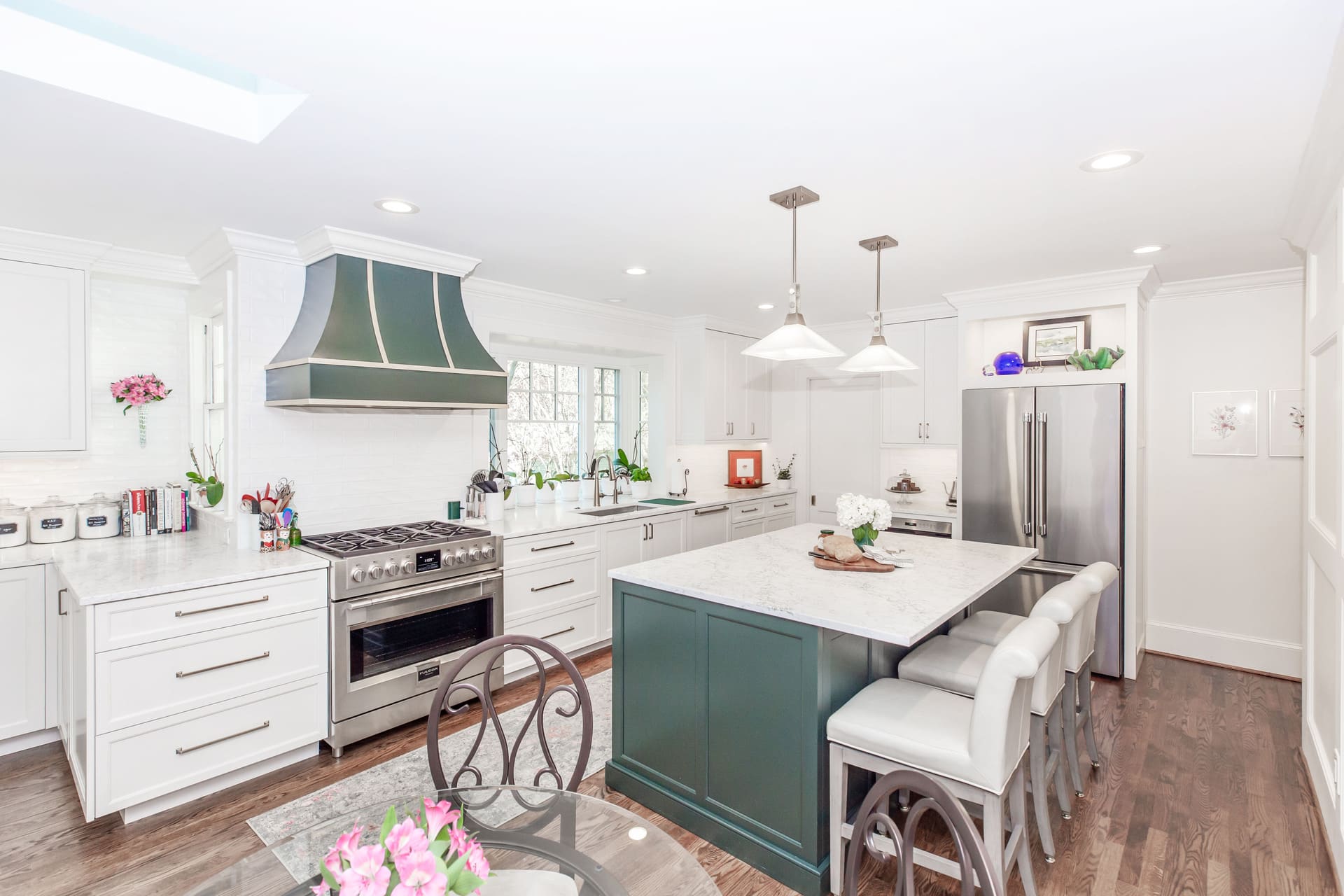 white and green kitchen with light fixtures