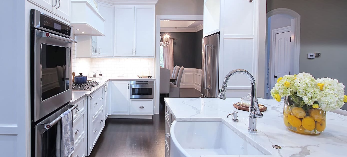 Farm-sink-pendent-lights-white-cabinets-marble-countertops-remodel