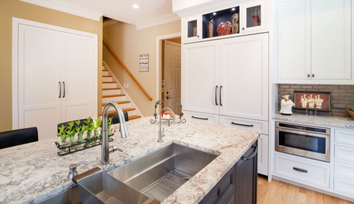 white kitchen beside a staircase