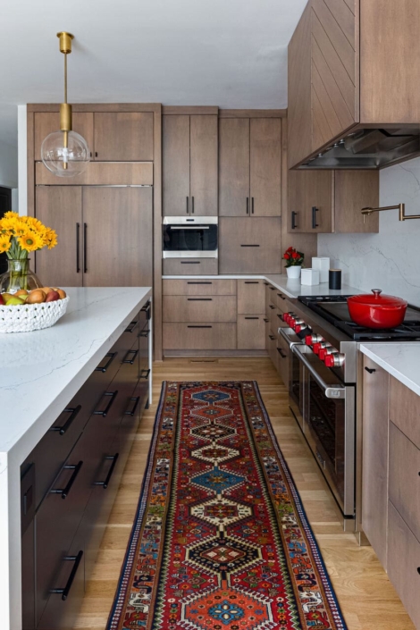 brown kitchen with a runner rug