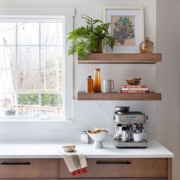 kitchen with floating shelves and a window